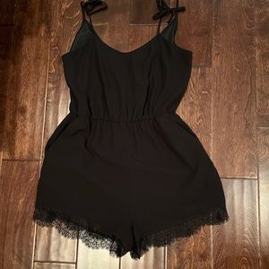 Black romper with lace detail on the leg! BCBG. Like new!
